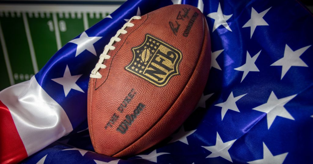 Madrid, Spain - 22 September 2021: Photoshoot with an NFL ball and an American flag.
