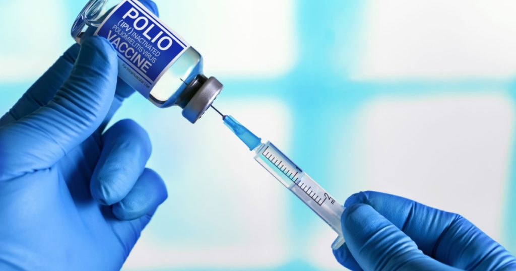 Vaccination for booster shot for Polio IPV Inactivated poliomyelitis Virus in the child population. Doctor with vial of the doses vaccine and syringe for Polio IPV Inactivated poliomyelitis Virus
