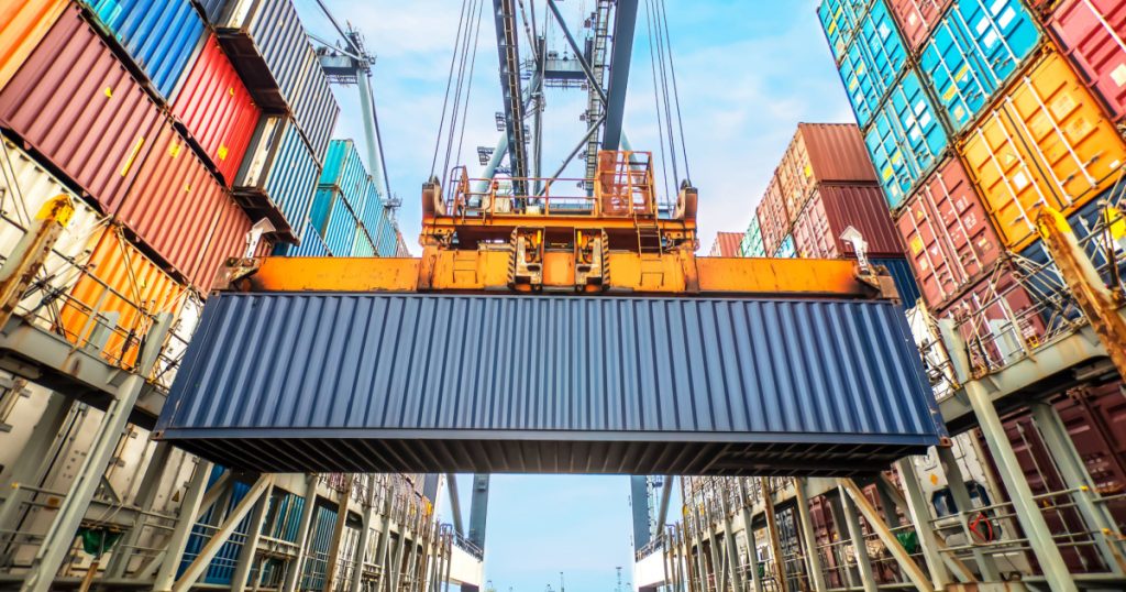 Container loading in a Cargo freight ship with industrial crane. Container ship in import and export business logistic company. Industry and Transportation concept.
