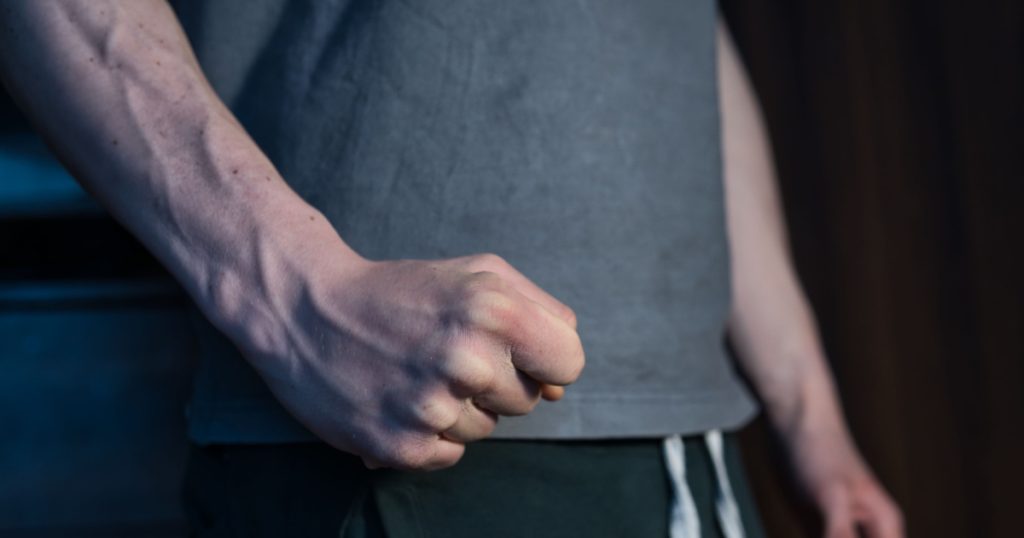 close-up on the fist of an aggressive man. a concept showing violence against people, domestic violence, frustration, irritation and anger
