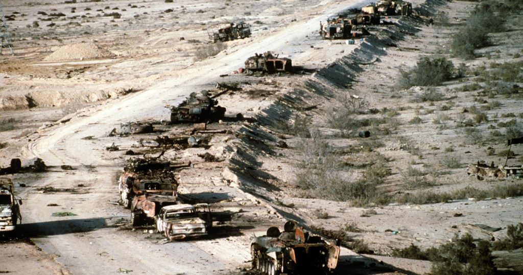 Iraqi armored personnel carriers tanks and trucks destroyed in a Coalition attack along a road in the Euphrates River Valley during Operation Desert Storm. March 4 1991
