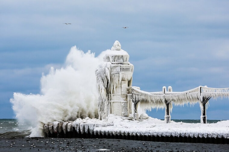 A frozen lighthouse and wave