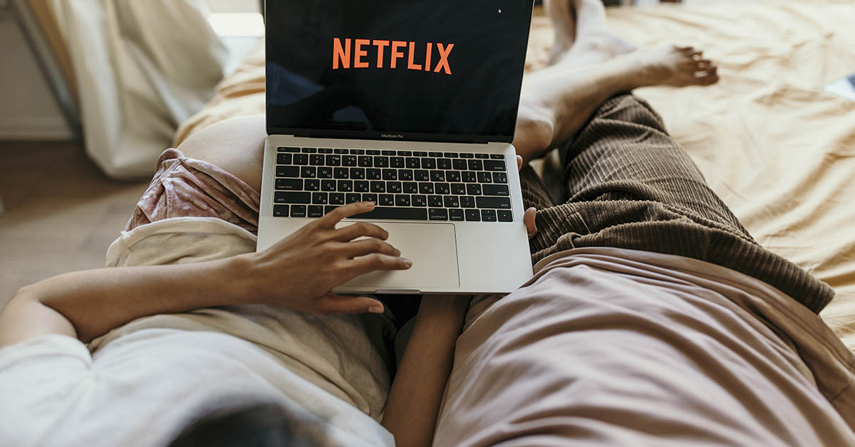 netflix on laptop in bed