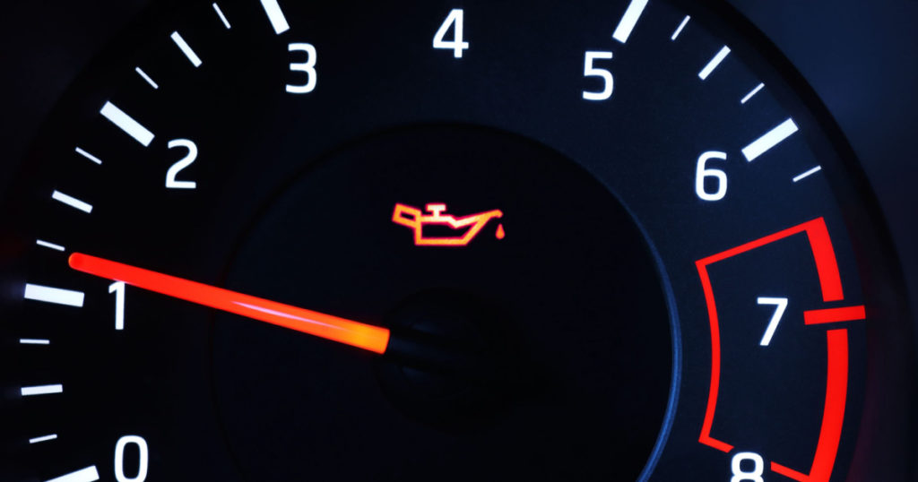Oil pressure warning light illuminated on dashboard.
