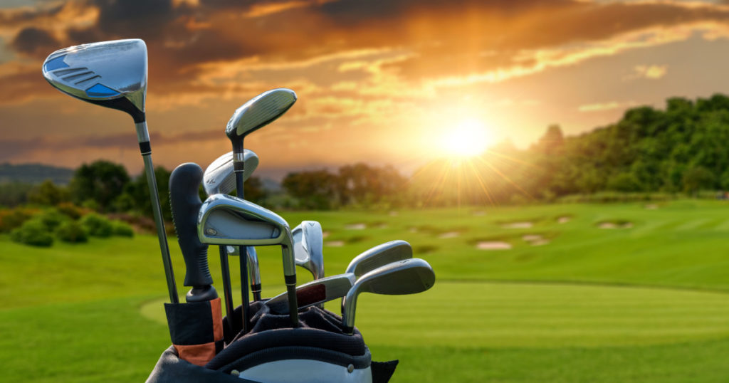 The Golf club bag for golfer training and play in game with golf course background , green tree sun rays.
