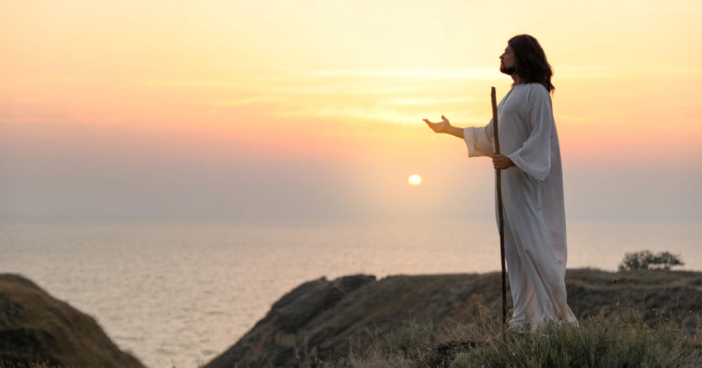 Jesus Christ on hills at sunset