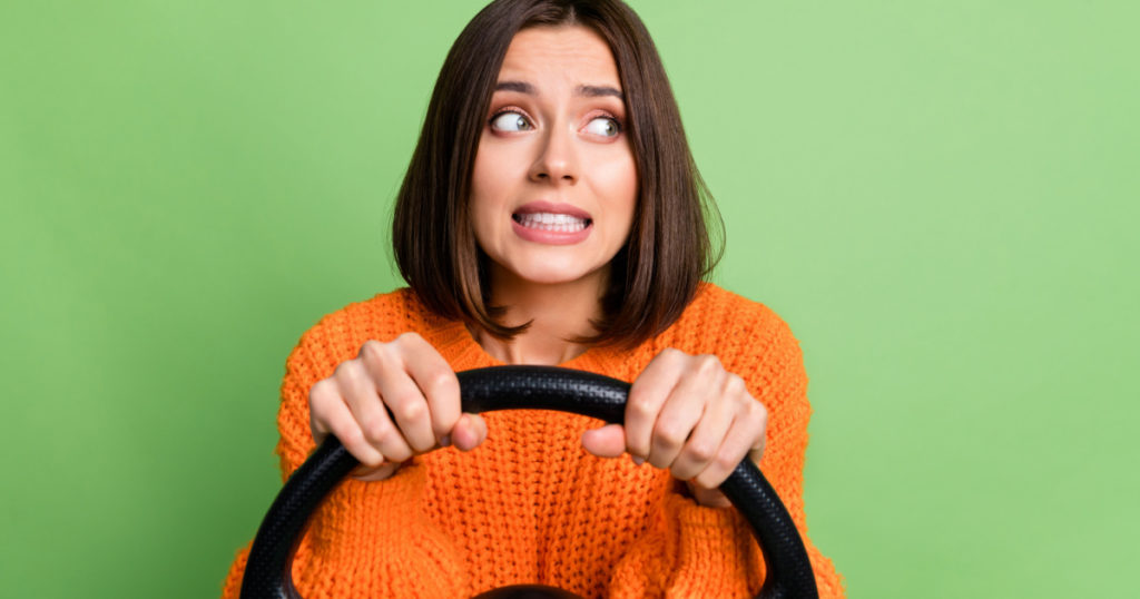 worried frustrated girl holding steering wheel