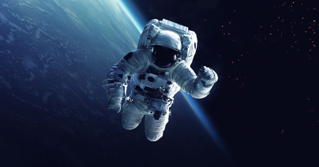 Astronaut at spacewalk. Cosmic art, science fiction wallpaper. Beauty of deep space. Billions of galaxies in the universe. Elements of this image furnished by NASA
