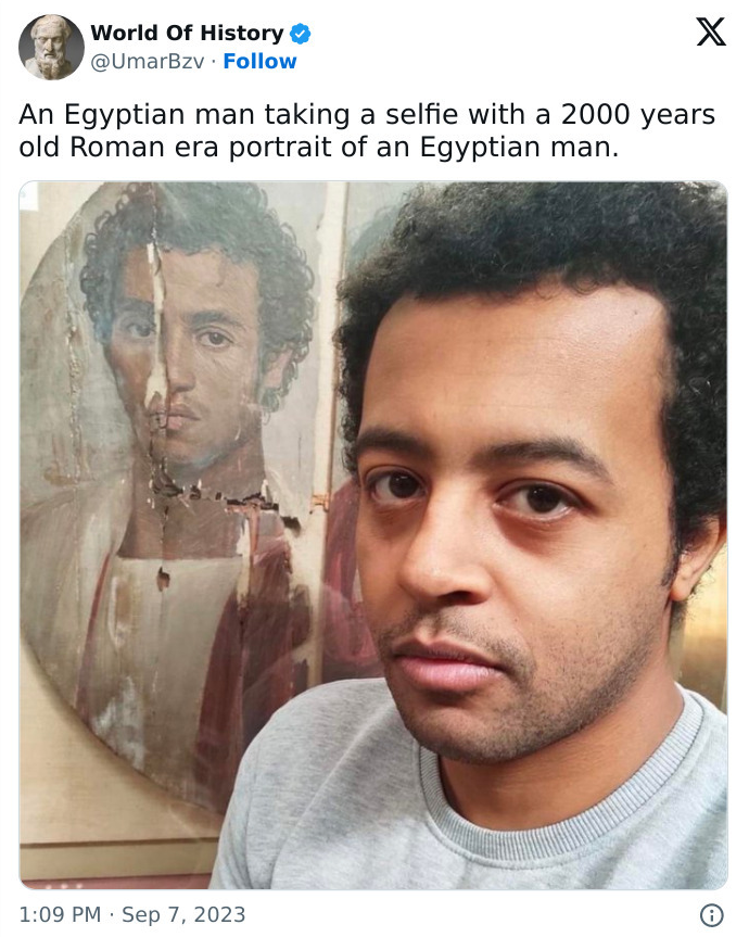 a man standing next to a 2000 year old Roman era portrait that looks just like him