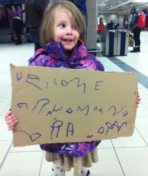 airport moments being greeted by your child holding a sign