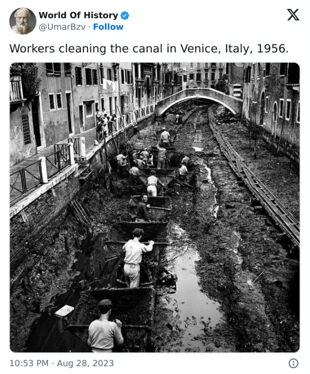 historical images  = Workers cleaning the Venice Canal in Italy - 1956