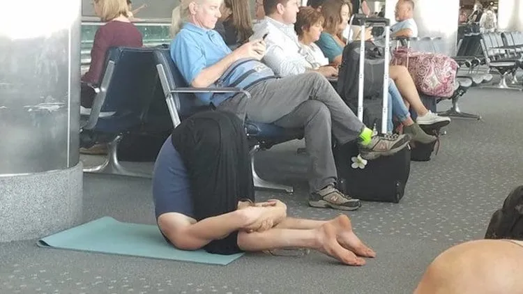 Man doing yoga at an aiport