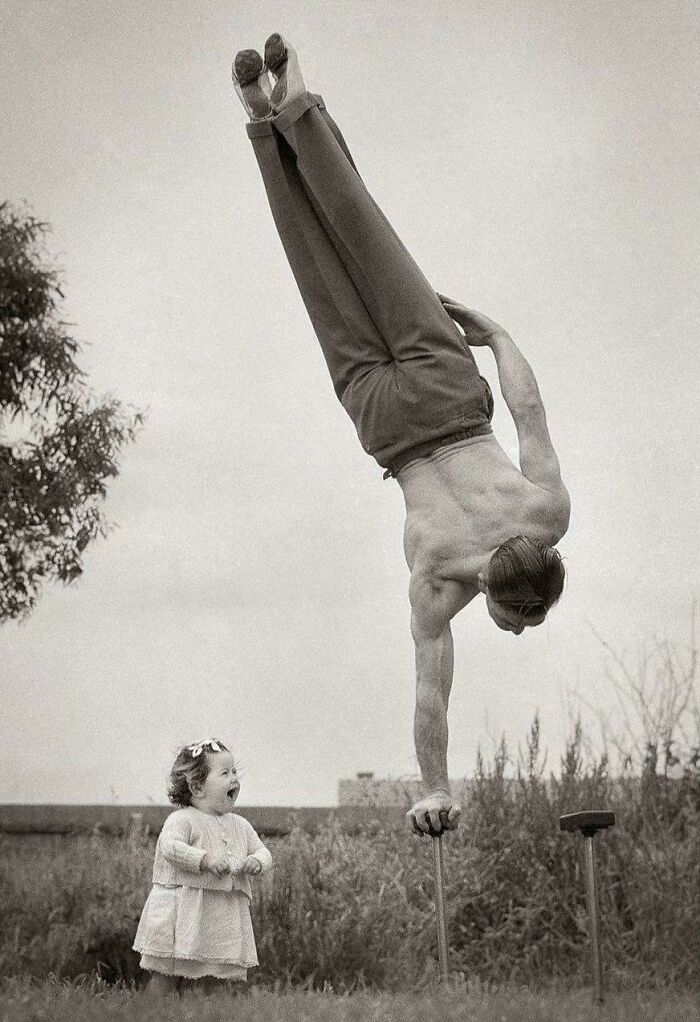 A little girl's sheer delight as she watches her dad perform an amazing balancing act