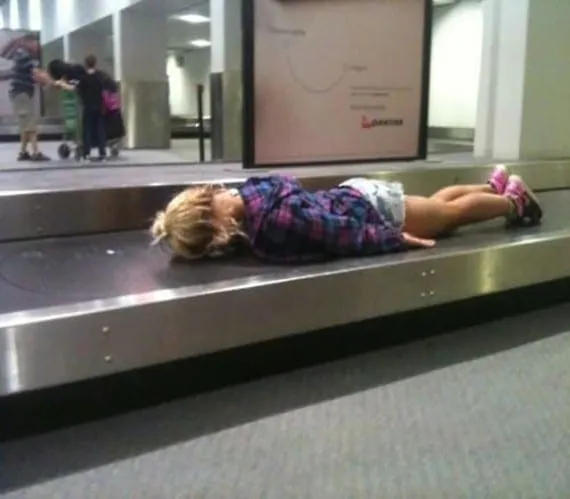 child on luggage conveyor belt.