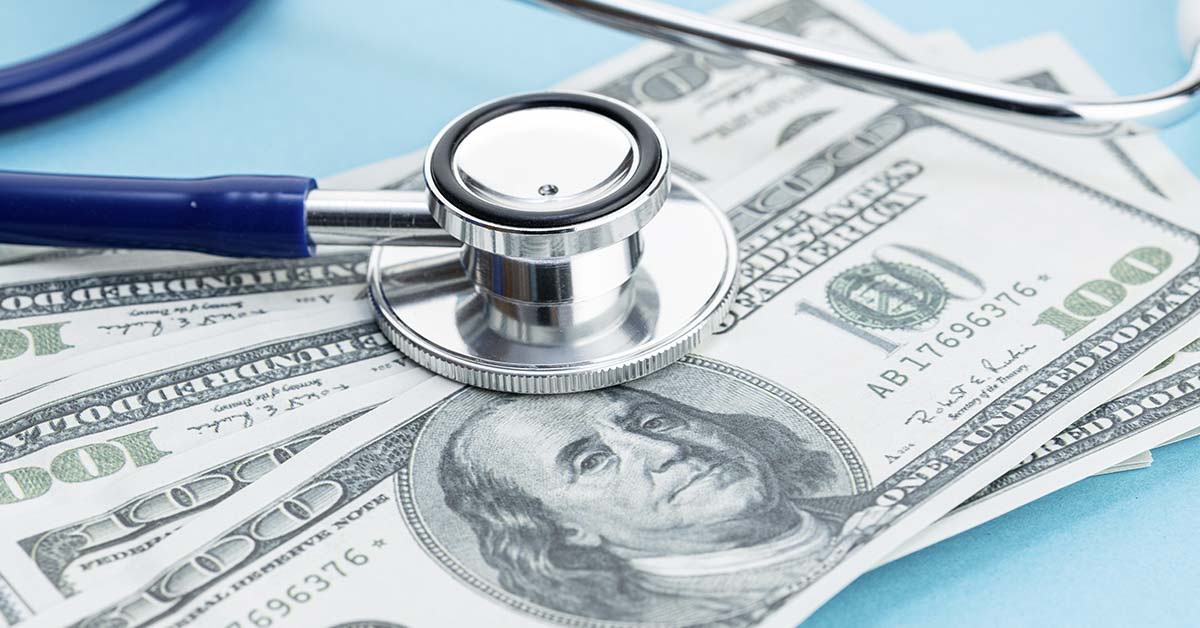 stethoscope placed on American currency. Medical debt concept