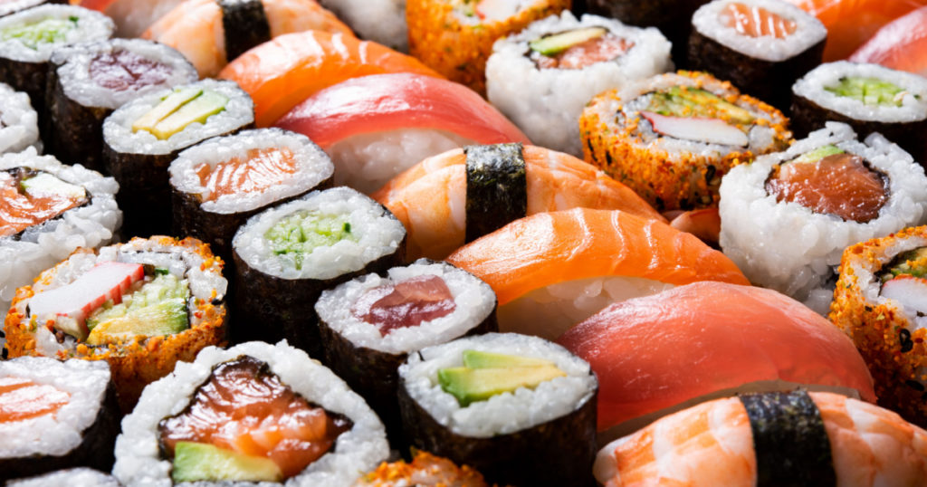 Overhead japanese sushi food. Maki ands rolls with tuna, salmon, shrimp, crab and avocado. Top view of assorted sushi, all you can eat menu. Rainbow sushi roll, uramaki, hosomaki and nigiri.
