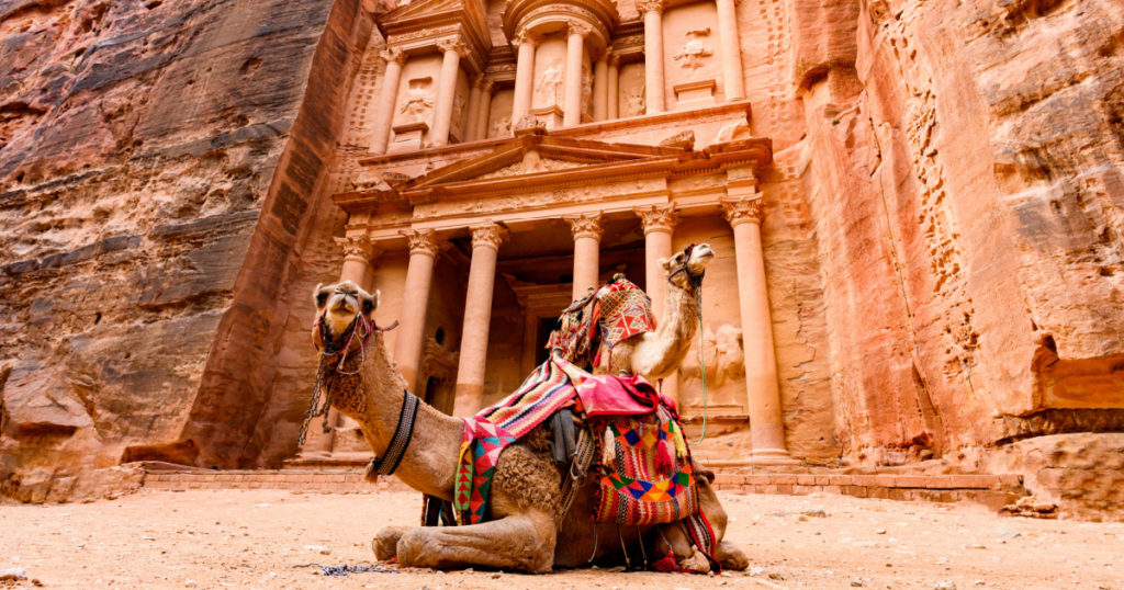 Spectacular view of two beautiful camels in front of Al Khazneh (The Treasury) at Petra. Petra is a historical and archaeological city in southern Jordan.
