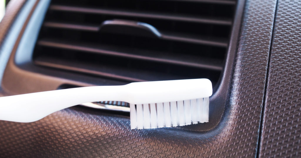 Cleaning inside the car by using a toothbrush at channel of air conditioning
