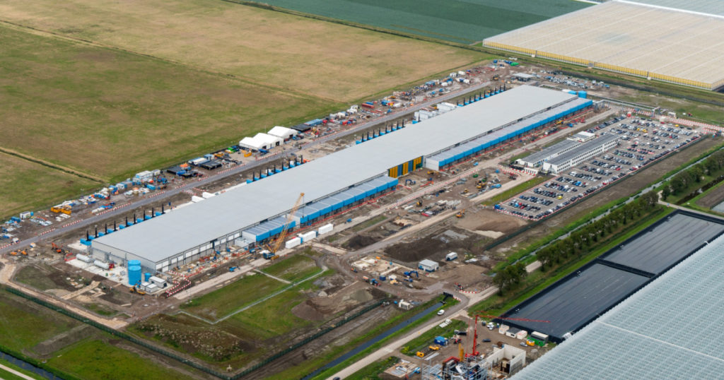 16 September 2019, Middenmeer, Netherlands. Aerial view of construction site for a new Google and Netflix datacenter. The huge building is located near Wieringerwerf in the province NOORD HOLLAND.
