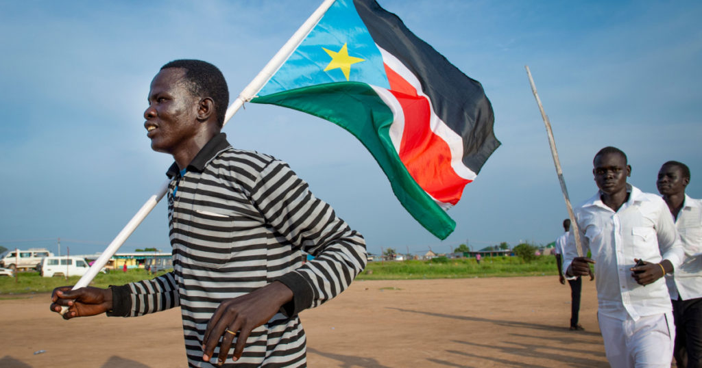 A man holds a South Sudanese flag in Juba on July 9, 2016 during celebrations as part of the country's fourth independence day.
