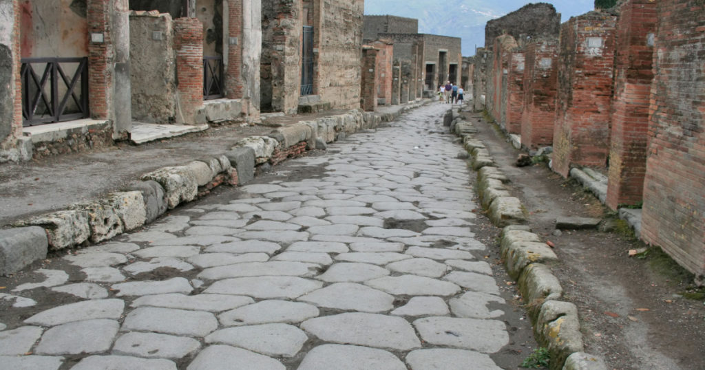 An antique roman stone street through ruins of Pompei,Italy.
