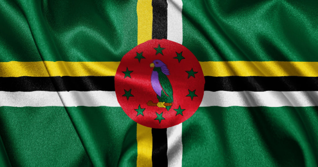 Close up realistic texture fabric textile silk satin flag of Dominica waving fluttering background. National symbol of the country. 3rd of November, Happy Day concept

