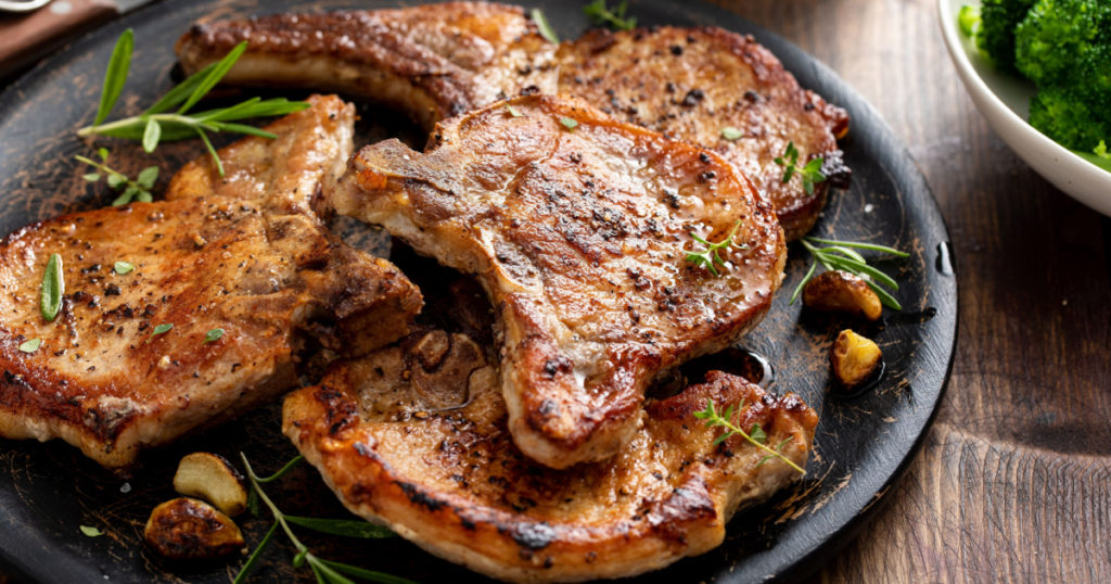 Grilled or pan fried pork chops on the bone with garlic and rosemary
