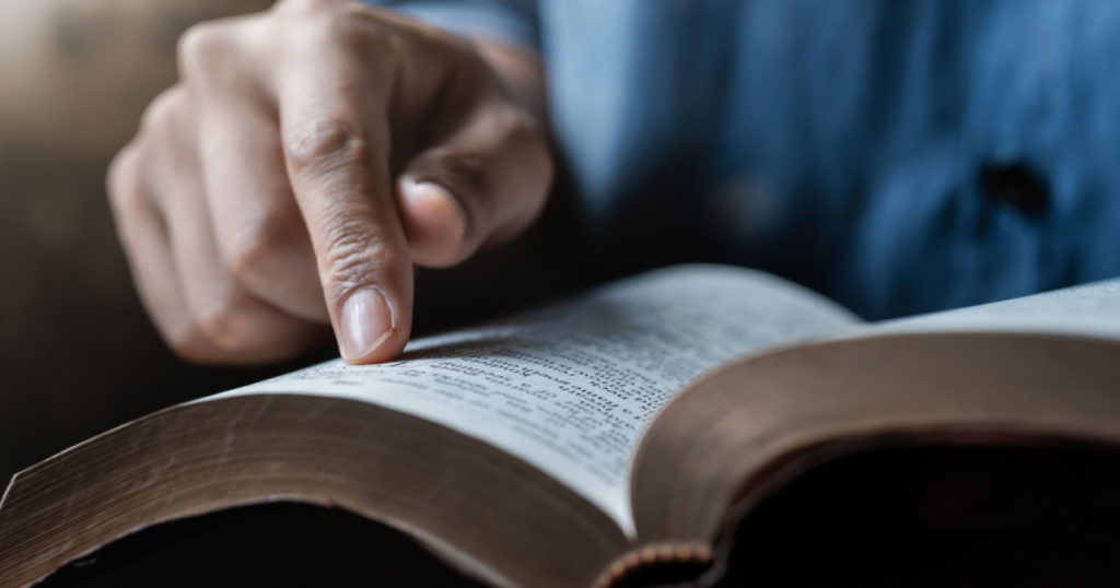 Close-up of a man reading the Bible Spiritual concepts by studying the Holy Scriptures together.
