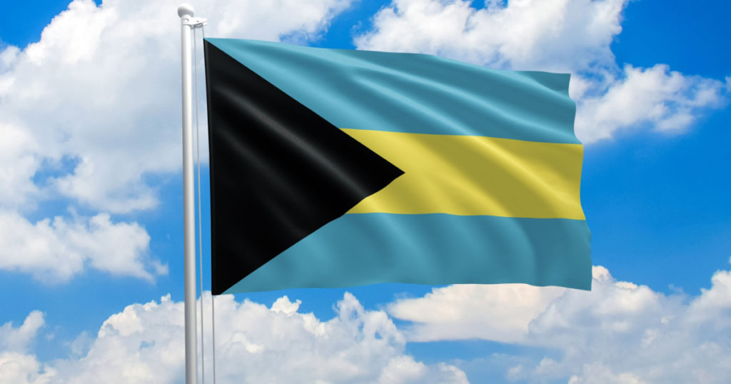 Bahamas national flag waving in the wind on clouds sky. High quality fabric. International relations concept
