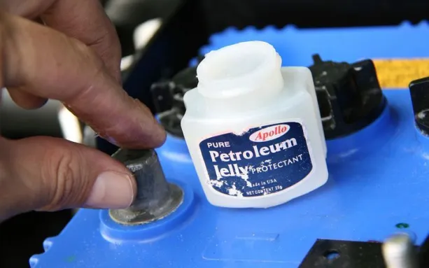 applying petroleum jelly to the terminals