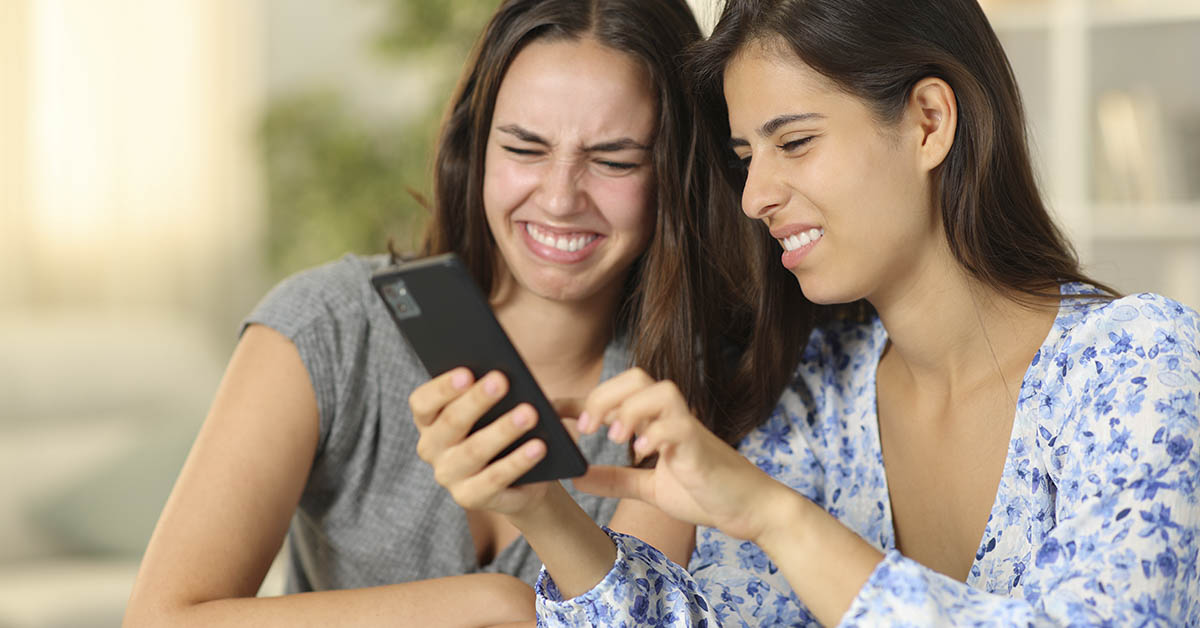 two young woman disgusted by something they see on their phone