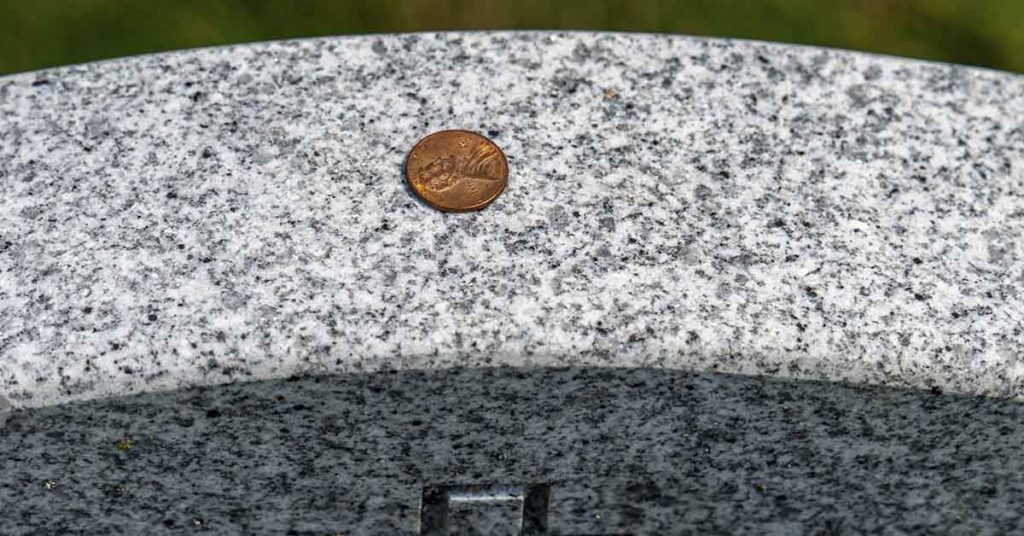 Why Do Some People Place Coins on Gravestones? - Featured image