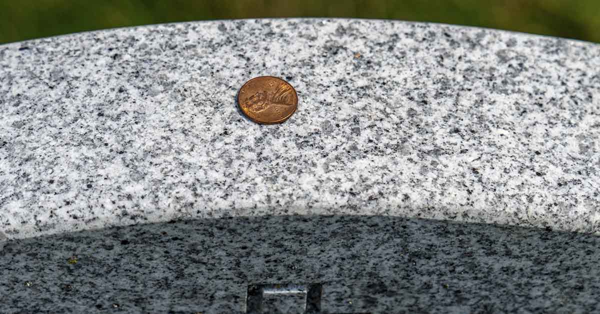 coin on a gravestone