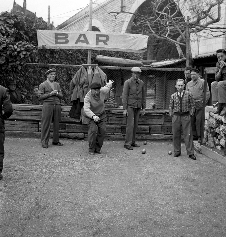 black and white image. men playing the game of boules 