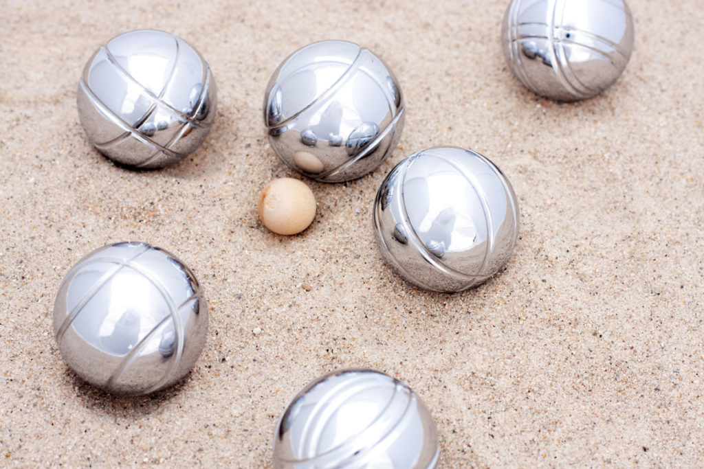 
Game of jeu de boule, silver metal balls in sand. A french ball game
