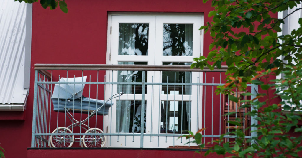 Reykjavik, Iceland, Europe, 08/30/2012: a vintage baby carriage on a balcony seen in the streets of the capital, the largest city of the island, the world's northernmost capital of a sovereign State
