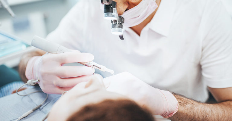 Woman Sues After Dental Appointment Included 4 Root Canals, 8 Crowns, and 20 Fillings - Featured image