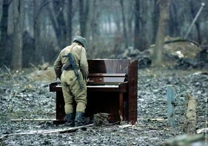 historical photos - a poignant photograph from 1994 captures a Russian soldier playing an abandoned piano in Chechnya