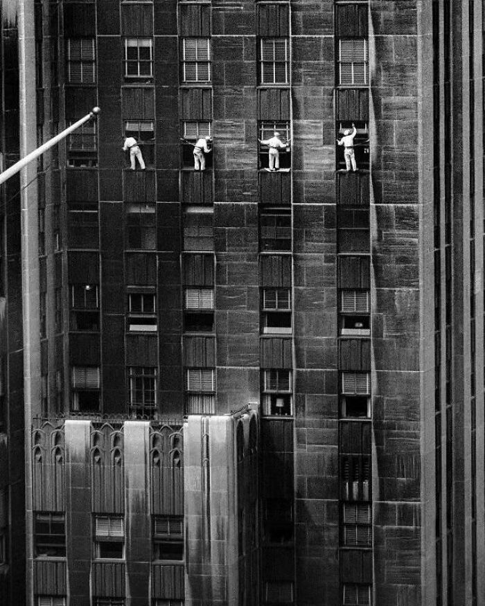1958 New York City, a captivating photograph immortalizes the daring window cleaners suspended high above the streets.