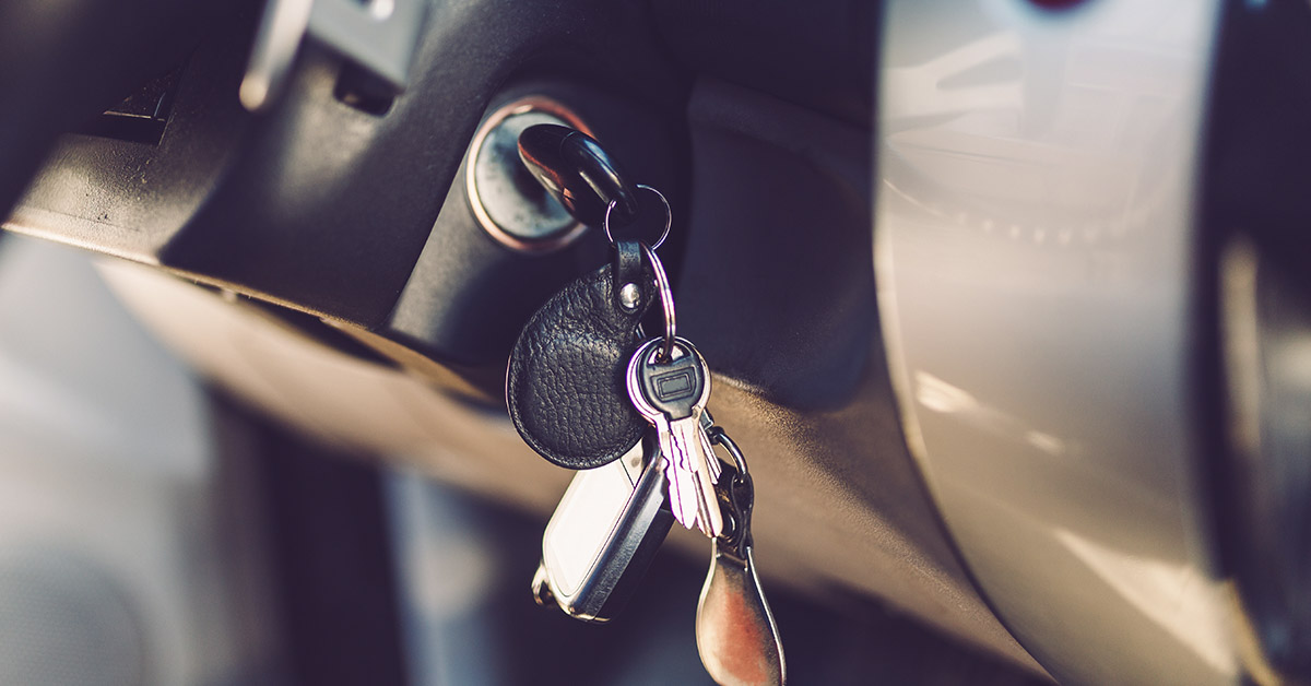 ignition key in car with other keys hanging from key chain