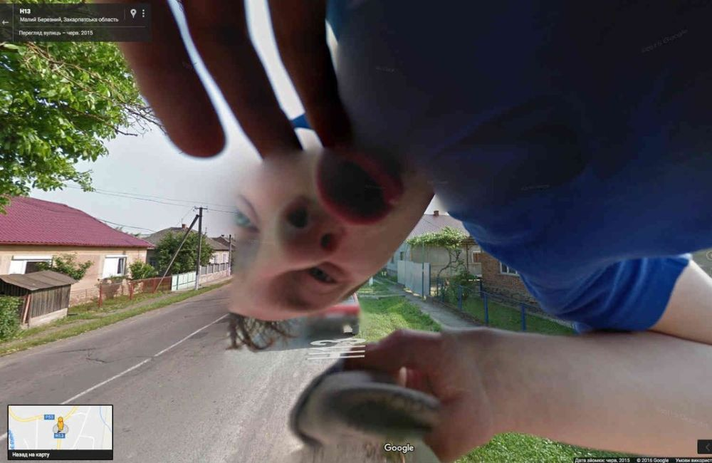 A weirdly distorted photo of a man making a strange face. Just another oddity on Google Street View.