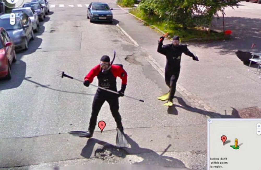 Two guys in scuba gear strolling down the street—no water in sight. Maybe it's a trend or just a couple of guys having fun with the Google car.