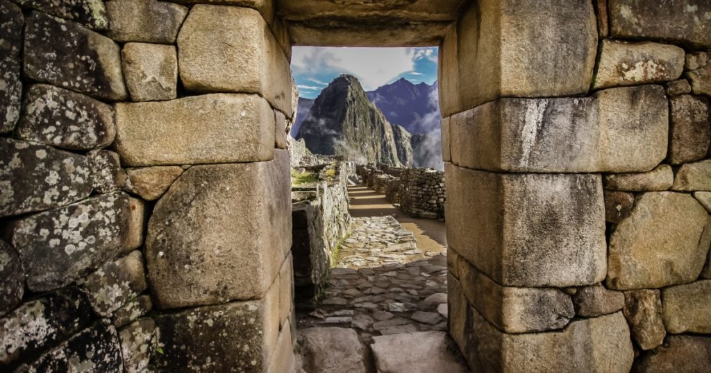 Doorway at Machu Picchu frames a view of Huayna Picchu, Machu Picchu, Unesco World Heritage site, Sacred Valley, Peru