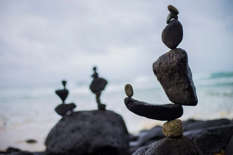 rocks balanced in front of a beach
